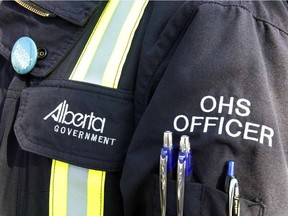 An Alberta Occupational Health and Safety officer stands at a press conference in Edmonton, May 12, 2014.