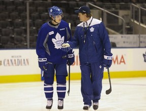 Former Toronto Maple Leafs coach Mike Babcock talks with Mitch Marner before a game against the Calgary Flames in Toronto on Monday, Jan. 23, 2017.
