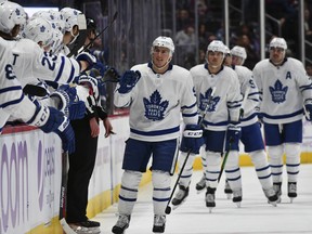 Toronto Maple Leafs defenceman Tyson Barrie is congratulated by his teammates after scoring in the first period against the Colorado Avalanche, his former team, on Saturday in Denver. (John Leyba/The Associated Press)