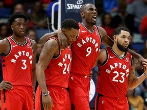 Toronto Raptors forward Serge Ibaka is helped off the court by guards Norman Powell and Fred VanVleet in the second quarter against the New Orleans Pelicans at the Smoothie King Center.