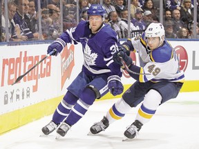 Maple Leafs' Rasmus Sandin and Blues' Ivan Barbashev battle for the puck during a game in October. (GETTY IMAGES)