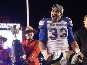 Winnipeg Blue Bombers' Andrew Harris collects the hardware after beating the Hamilton Tiger-Cats in the 107th Grey Cup at McMahon stadium in Calgary on Sunday, November 24, 2019. Darren Makowichuk/Postmedia
