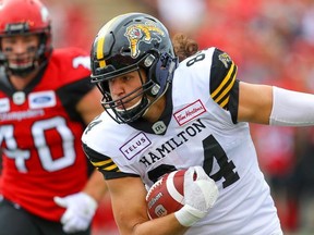 Hamilton Tiger-Cats Nikola Kalinic runs the ball against the Nate Holley of the Calgary Stampeders during CFL football in Calgary on Saturday, September 14, 2019.