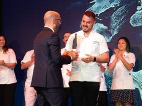 Thomas Conquet, marketing director for S.Pellegrino, (left) awards Chef Rafael Covarrubias, 25, of Hexagon Restaurant in Oakville (right) as the winner of the S.Pellegrino Young Chef Competition North American Regional Semifinal on November 5, 2019 in New York City. (Photo Credit: S.Pellegrino Sparkling Natural Mineral Water)