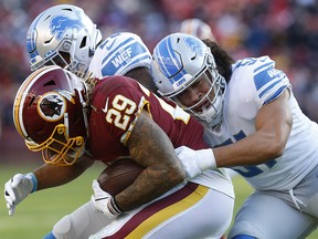 Washington Redskins running back Derrius Guice (29) is tackled by Detroit Lions linebacker Jahlani Tavai (51) at FedExField. (Geoff Burke-USA TODAY Sports)