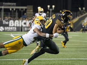 Hamilton Tiger Cats wide receiver Jaelon Acklin (80) is tackled by Edmonton Eskimos defensive back Monshadrik Hunter (41) during first half CFL football game action in Hamilton, Ont., Friday, Oct. 4, 2019.