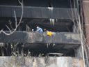 Toronto Fire and the Ontario Fire Marshal’s investigators on the eighth floor balcony where a person died when flames erupted at a highrise on Gosford Blvd. on Friday, Nov. 15, 2019. (Jack Boland/Toronto Sun/Postmedia Network)