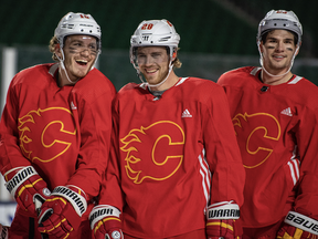 Flames' Matthew Tkachuk (left) and Sean Monahan (right) switched lines for two games -- with Elias Lindholm (middle) centring the top unit -- but the team put things back the way they were on Thursdy after two low-scoring games. Liam Richards/The Canadian Press