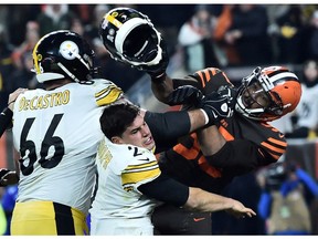 Cleveland Browns defensive end Myles Garrett hits Pittsburgh Steelers quarterback Mason Rudolph with his own helmet as offensive guard David DeCastro tries to stop Garrett during the fourth quarter at FirstEnergy Stadium.