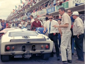 24 Hours of LeMans, LeMans, France, 1965. Carroll Shelby stands at the rear of the Ford Mark II prototype that Phil Hill and Chris Amon drove. CD#0777-3292-0630-15.