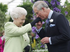 LONDON - MAY 18:  Queen Elizabeth II presents Prince Charles, Prince of Wales with the Royal Horticultural Society's Victoria Medal of Honour during a visit to the Chelsea Flower Show on May 18, 2009 in London. The Victoria Medal of Honour is the highest accolade that the Royal Horticultural Society can bestow. (Photo by Sang Tan/WPA Pool/Getty Images)