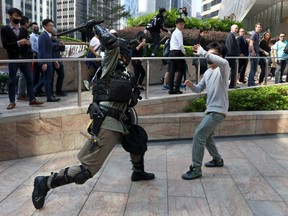 A riot officer clashes with an anti-government protester during a demonstration at the Central District in Hong Kong, China, on Wednesday, Nov. 13, 2019.