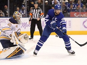 Toronto Maple Leafs forward John Tavares deflects the puck as Buffalo Sabres goalie Carter Hutton defends in the second period at Scotiabank Arena.