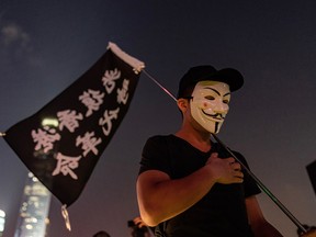 People attend a prayer in memory of university student Alex Chow, who succumbed to head injuries sustained during a fall as police skirmished with demonstrators, on November 9, 2019 in Hong Kong, China.