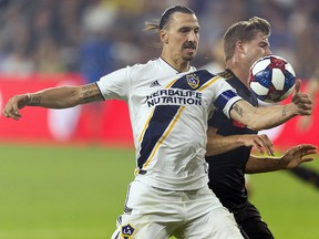 Los Angeles Galaxy forward Zlatan Ibrahimovic (9) and Los Angeles FC defender Walker Zimmerman (25) battle for the ball at Banc of California Stadium. (Kelvin Kuo-USA TODAY Sports)