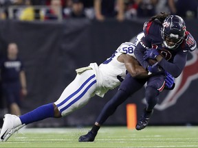 DeAndre Hopkins  of the Houston Texans is tackled by Bobby Okereke of the Indianapolis Colts after a catch in the fourth quarter at NRG Stadium on Nov. 21, 2019 in Houston, Texas.  (Tim Warner/Getty Images)