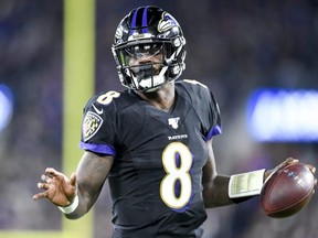 Ravens quarterback Lamar Jackson runs the ball in for a touchdown during first quarter NFL action against the Patriots at M&T Bank Stadium in Baltimore, on Nov. 3, 2019.