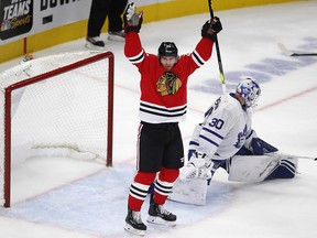 Chicago Blackhawks forward Brandon Saad, left, celebrates his goal on Toronto Maple Leafs' Michael Hutchinson Sunday, Nov. 10, 2019, in Chicago. (AP Photo/Jim Young)