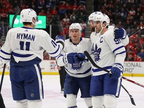 Maple Leafs captain John Tavares is congratulated by teammates after scoring against the Red Wings in Detroit on Wednesday night. (Gregory Shamus/Getty Images)