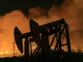 Pump jacks at an oil extraction site are seen at the Maria fire, which exploded to 8,000 acres on its first night on Nov. 1, 2019 near Somis, Calif.