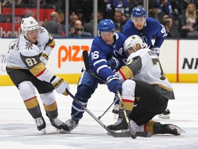 Golden Knights' Jonathan Marchessault and William Karlsson battle against Maple Leafs' Mitch Marner  on Thursday night at Scotiabank Arena in Toronto. (GETTY IMAGES)