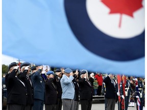 The Royal Canadian Air Force flag flies as veterans salute during a ceremony marking the 79th anniversary of the Battle of Britain in Ottawa on Sunday, Sept. 15, 2019.