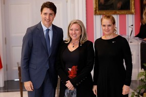 Mona Fortier poses with Canada’s Prime Minister Justin Trudeau and Gov. Gen. Julie Payette after being sworn-in as Minister of Middle Class Prosperity and Associate Minister of Finance during the presentation of Trudeau’s new cabinet at Rideau Hall in Ottawa, Ontario, Canada, on Nov. 20, 2019. (Reuters/Blair Gable)