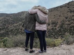 Women mourn as a convoy of vehicles bearing the coffins of Rhonita Miller and her four children pass by the site of the attack as they travel from their home village located in Rancho La Mora for their burial in a family plot, on November 08, 2019. (HERIKA MARTINEZ/AFP via Getty Images)