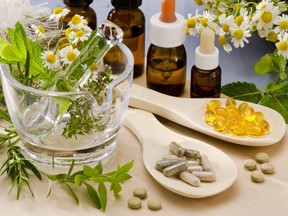 Rosemary, mint, chamomile, thyme in a glass mortar. Essential oils and herbal supplements.