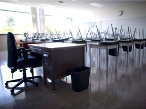 A empty teacher's desk is pictured in an empty classroom at Mcgee Secondary school in Vancouver on Sept. 5, 2014.