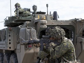 MCpl. Ryan Vogrig, of 1 PPCLI, watches a tank attack during Exercise Promethean Ram, a live fire training exercise held in Wainwright, Alberta on April 21, 2016. (Greg Southam/Postmedia Network)