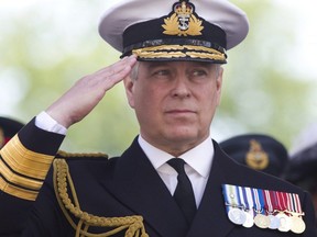In this file photo taken on June 27, 2015, Britain's Prince Andrew, Duke of York salutes military personnel during the Armed Forces day parade in Guildford.