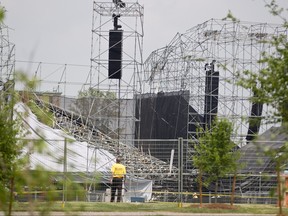 In this June 18, 2012 file photo, investigators survey the scene at Downsview Park in Toronto following a stage collapse just before a Radiohead concert, which left one man dead and 3 others injured. (GEOFF ROBINS/AFP/Getty Images)