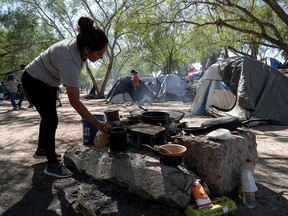 A woman cooks in the Matamoros camp, in Matamoros, Tamaulipas state, Mexico, near to the border with the United States, on November 1, 2019. (LEXIE HARRISON-CRIPPS/AFP via Getty Images)