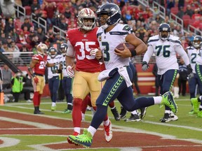 Seahawks quarterback Russell Wilson (3) scores on a 2-yard touchdown run against the 49ers during NFL action at Levi's Stadium in Santa Clara, Calif, on Nov. 26, 201.