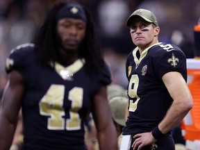 New Orleans Saints quarterback Drew Brees (9) looks on from the bench against the Atlanta Falcons at the Mercedes-Benz Superdome. Saints running back Alvin Kamara (41) is at left. (Chuck Cook-USA TODAY Sports)