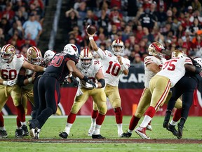 San Francisco 49ers quarterback Jimmy Garoppolo throws a pass against the Arizona Cardinals during the second half of the NFL game at State Farm Stadium on Oct. 31, 2019, in Glendale, Ariz.