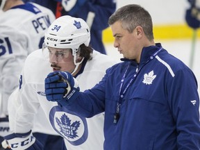 Maple Leafs head coach Sheldon Keefe talks with young star Auston Matthews during practice at the Ford Performance Centre on Monday. (Craig Robertson/Toronto Sun)
