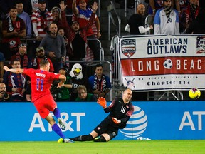 Handout picture released by CONCACAF showing Canada's goalie Milan Borjan failing to stop a ball from U.S.' Jordan Morris during their CONCACAF Nations League A tournament football match at the Exploria Stadium in Orlando, Fla., on Nov. 15, 2019.