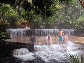 Guests relax at Tabacon Thermal Resort’s hot springs. (Ling Hui/Postmedia Network)