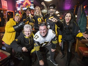 A group of fans get into the Grey Cup spirit in Hamilton, Ont. on Friday, Nov. 22, 2019. (Craig Robertson/Toronto Sun/Postmedia Network)
