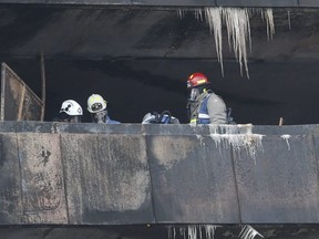 Toronto firefighters and an investigator with the Ontario Fire Marshal's office investigate a fatal fire that took place in an eighth-storey apartment on Gosford Blvd., on Saturday, Nov. 16, 2019.