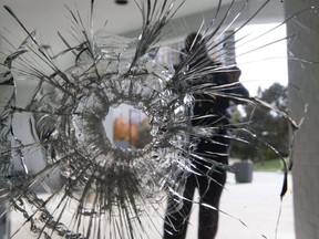 Toronto Police Services investigate the bullet-riddled scene at the front entrance of an apartment building near Trethewey and Black Creek,  on Monday November 4, 2019. Stan Behal/Toronto Sun/Postmedia Network