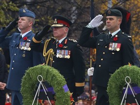 Gen. Jonathan Vance, Chief of the Defence Staff, centre, salutes during Remembrance Day ceremonies at the National War Memorial in Ottawa on Friday, Nov. 11, 2016. (Patrick Doyle)