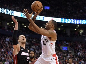 Toronto Raptors guard Norman Powell  shoots the ball over Miami Heat forward Kelly Olynyk during Tuesday's game. (USA TODAY SPORTS)