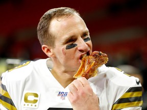 Drew Brees of the New Orleans Saints bites into a turkey leg after their 26-18 win over the Atlanta Falcons last week. (GETTY IMAGES)