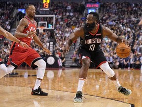 Houston Rockets guard James Harden dribbles the ball against Toronto Raptors guard Norman Powell during Thursday's game. (USA TODAY SPORTS)
