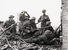 Canadian troops survey the enemy at Ortona, Italy, in December 1943.