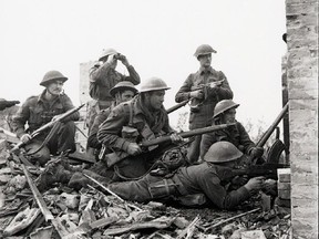 Canadian troops survey the enemy at Ortona, Italy, in December 1943.