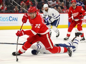 Andreas Athanasiou  of the Detroit Red Wings takes a shot around the stick of Justin Holl of the  Leafs at Little Caesars Arena on November 27, 2019 in Detroit, Michigan. Toronto won the game 6-0. (Photo by Gregory Shamus/Getty Images)